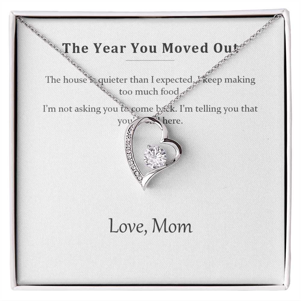Silver heart pendant necklace resting on its printed message card in a white gift box