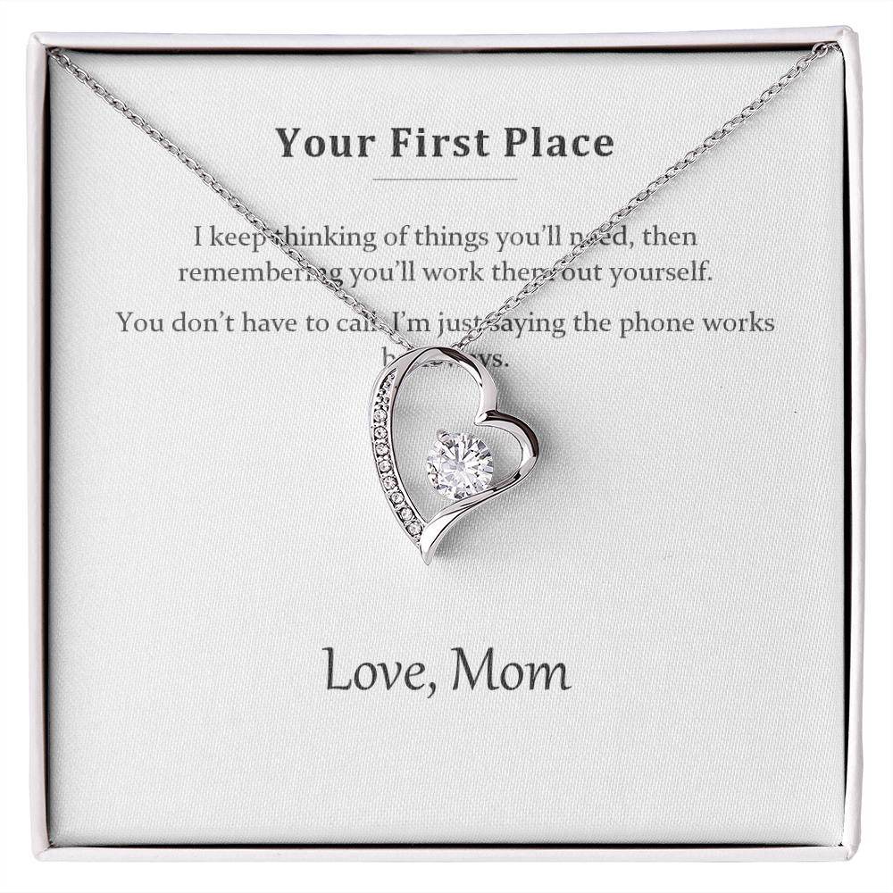 The Your First Place message card necklace in its open gift box