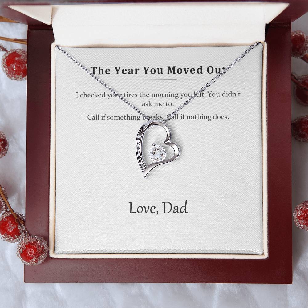 Silver heart necklace on the message card, styled with red winter berries