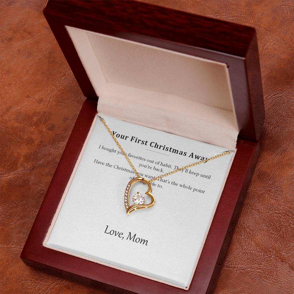 Open luxury gift box showing the gold heart pendant on the printed message card