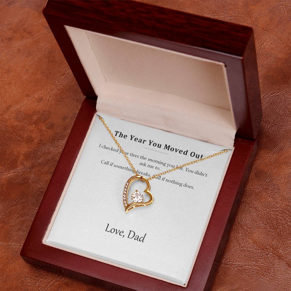 Open luxury gift box showing the gold heart pendant on the printed message card
