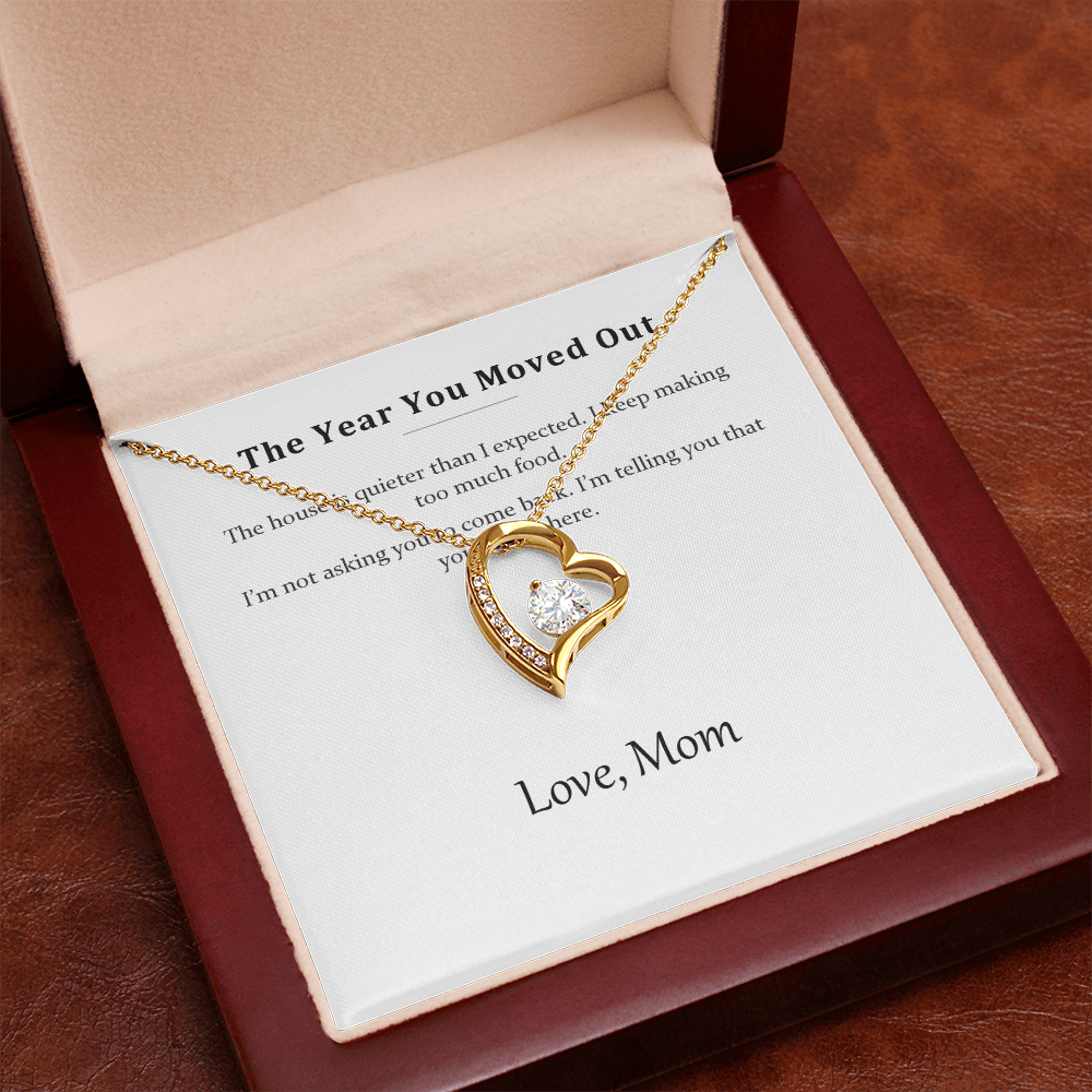Gold heart necklace displayed on the message card inside the luxury gift box