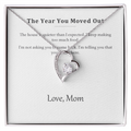 Silver heart pendant necklace on a printed message card reading The Year You Moved Out, in a white gift box