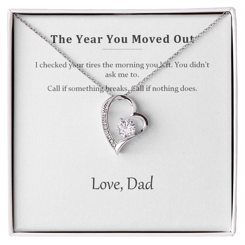 Silver heart pendant necklace on a printed message card reading The Year You Moved Out, signed Love Dad, in a white gift box