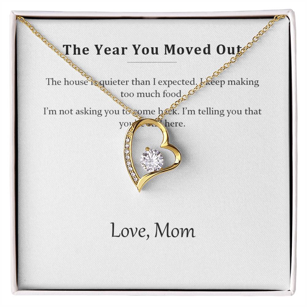 Gold heart pendant necklace on the printed message card in a white gift box