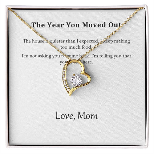 Gold heart pendant necklace on the printed message card in a white gift box