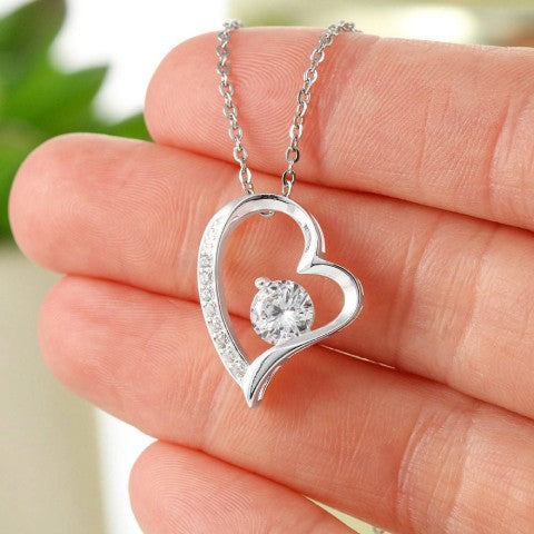 The heart pendant held against a hand, showing how large it actually is